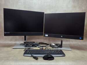 HP ProOne 440 All-in-One desktop computer with an additional monitor, mouse, and keyboard