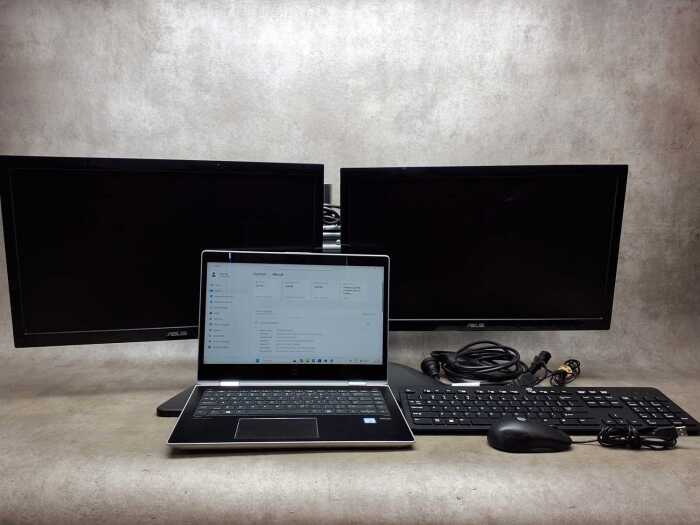 HP Pro Book laptop plus keyboard, two ASUS monitors, mouse and cables