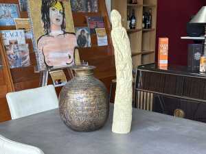 Two Asian decorator pieces including a Chinese sculpture in the shape of an elephant tusk and an 'Indian' pot.