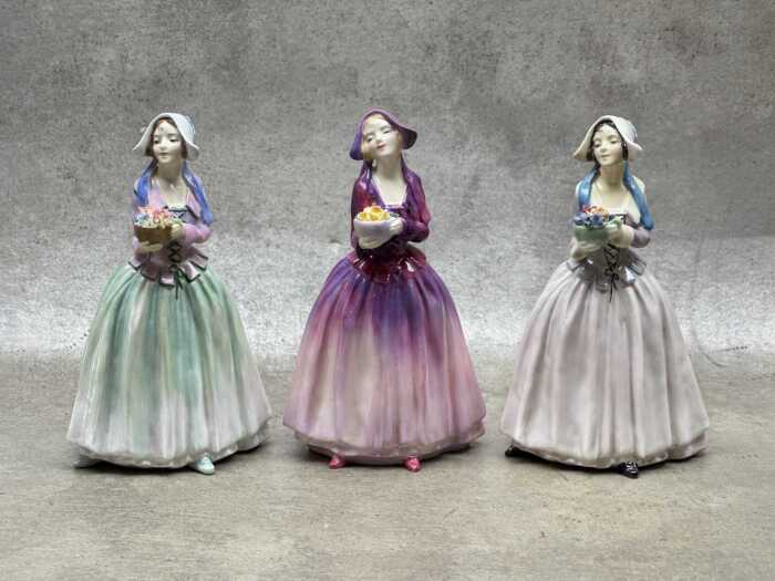 Three Royal Doulton 'Dorcas' porcelain figures in different colourways