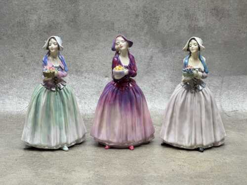 60 · Three Royal Doulton 'Dorcas' porcelain figures in different colourways