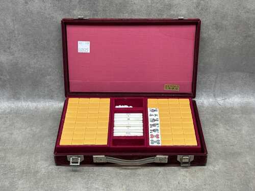 Vintage mahjong set with yellow-backed tiles