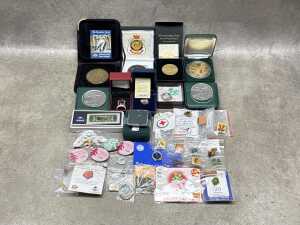 A tin of badges, medallions, and a tiny gold nugget