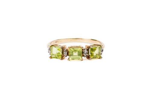 A peridot and diamond ring in 9 carat yellow gold