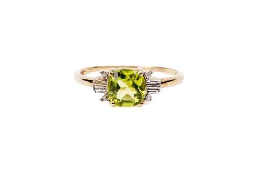 A peridot and diamond ring in 9 carat yellow gold