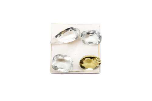A golden beryl and three aquamarines