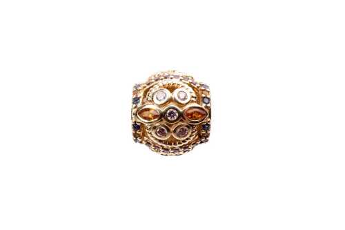 A retired Pandora Fresco cubic zirconia charm in 14 carat yellow gold