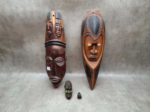 Traditional ethnic figural carvings including 2x timber masks and 2x stone heads