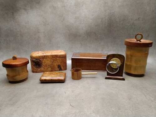 Six timber boxes and a timber mounted desk clock fitted with antique pocket watch