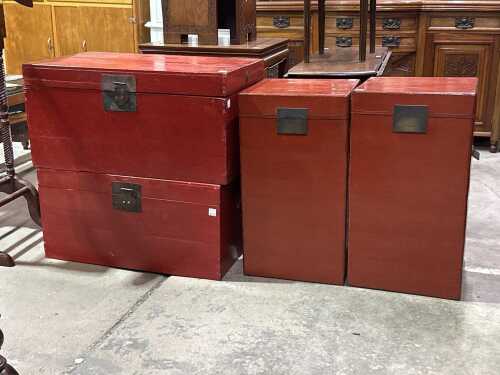 Four red travel trunks