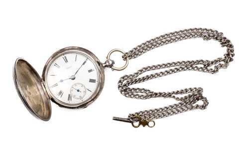 An antique pocket watch and chain in sterling silver.