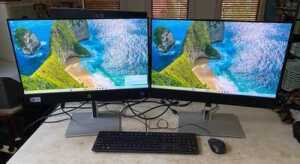 HP ProOne 440 All-in-One desktop computer with an additional monitor, mouse, and keyboard - 2