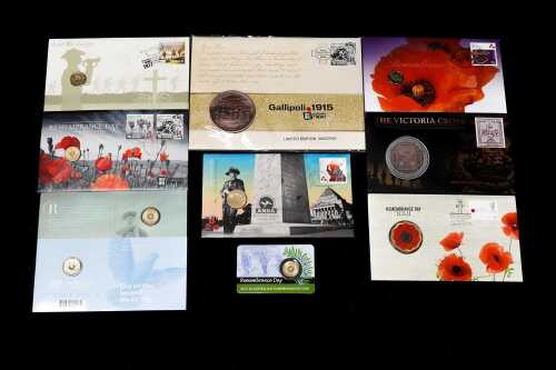 A group of Remembrance-themed collectable coins and PNCs
