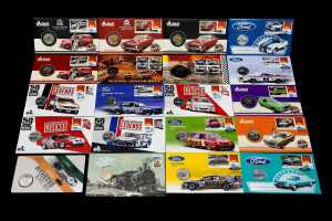 Group of motor racing-themed collectable coins and PNCs