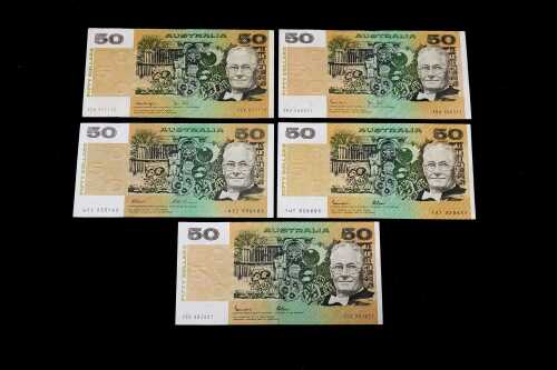 Five Australian $50 paper banknotes