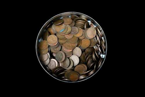 A tin of mostly Australian pennies and half pennies