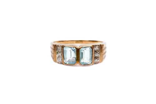 A blue topaz and diamond ring in 9 carat yellow gold