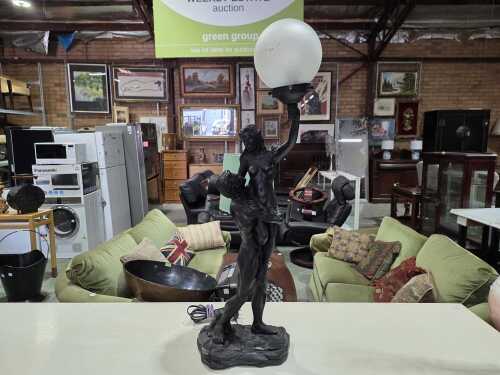 A resin figural lamp depicting lovers embracing