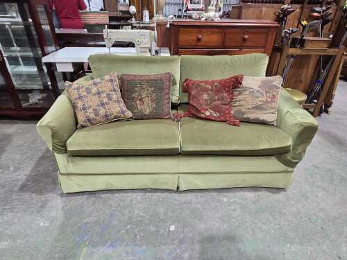 Pair of sage green velvet two-seater sofas