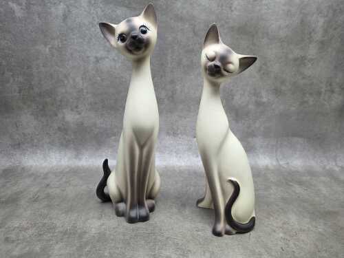 Pair of ceramic long-necked Siamese cat figures