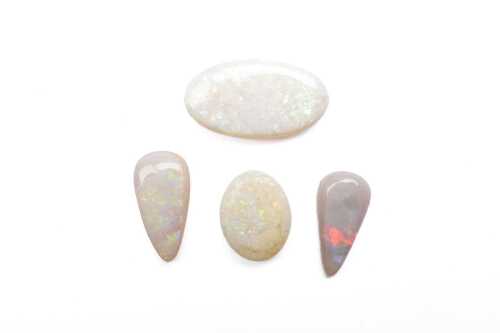 Four cabochon white opals