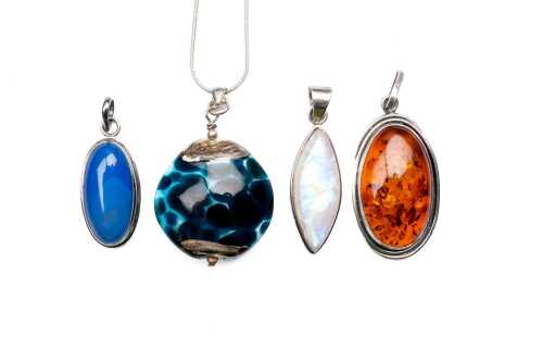 Collection of four pendants in sterling silver