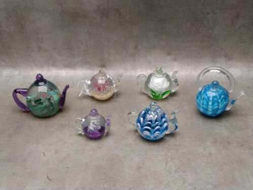 Collection of glass teapot-shaped paperweights