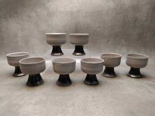 Eigth pottery desert bowls with incised teardrop decoration