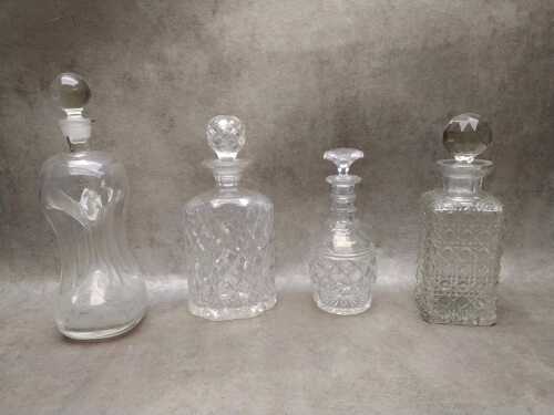 Four crystal and glass decanters
