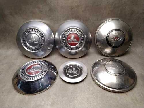 Six Holden chrome-plated hubcaps