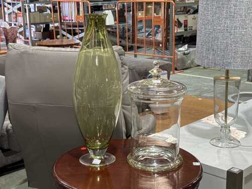 Two large decorative glass items including an apothecary jar and a green vase