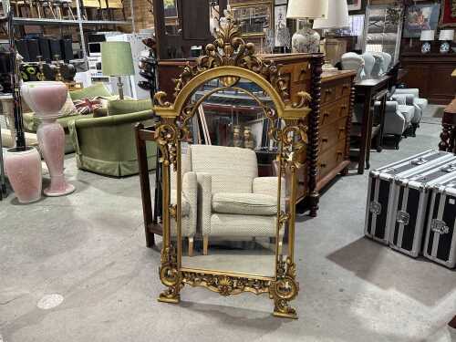 Giltwood framed mirror with dramatic scrolling and acanthus leaf crest