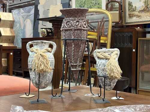 Set of three stoneware vases on black metal stands