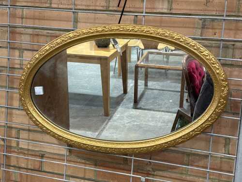 Oval ornate gilt mirror with chain mount
