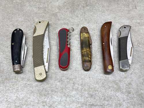 Six pocket knives including Humvee
