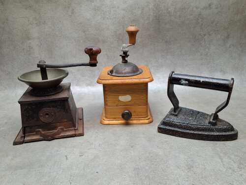 Three antique household items including two coffee grinders and an iron