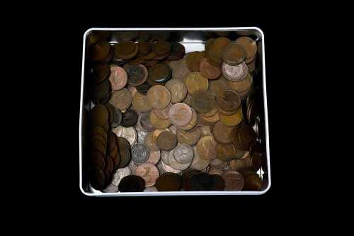 A tin of mostly Australian pennies and half pennies.