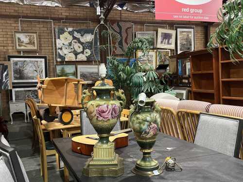Two green porcelain urn-form lamps with floral and figural designs