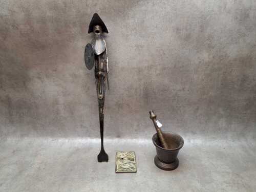 Two brass items including a stylised figure of a knight and a pestle and mortar.