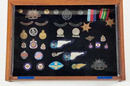 Collection of Australian Military Forces badges and medals in timber display box