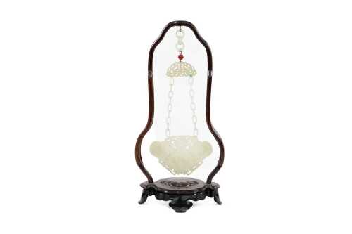 Chinese white jade plaque carved with bat figures, suspended in rosewood frame.