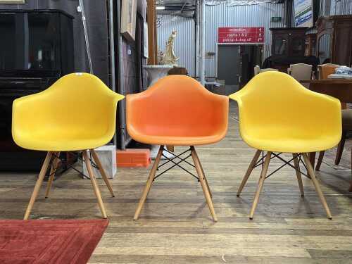 52 · Three replica Eames moulded plastic armchairs