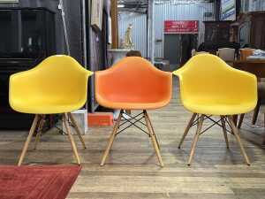 Three replica Eames moulded plastic armchairs