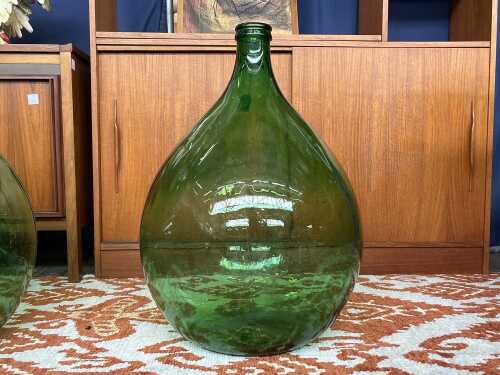 Vintage demijohn glass bottle in green