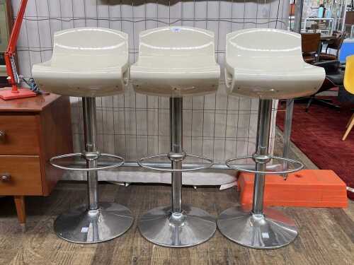 Three contemporary gas-lift bar stools