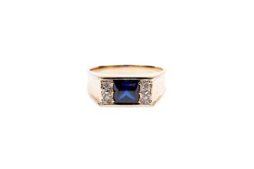 A synthetic sapphire and diamond signet ring in 9 carat yellow gold