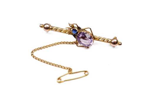 An antique amethyst and blue spinel bug brooch in 15 carat yellow gold