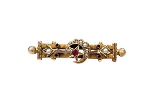 An antique garnet and seed pearl brooch in 9 carat yellow gold
