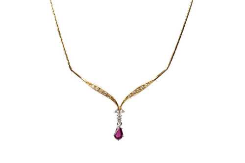 A ruby and diamond necklace in 18 carat yellow gold
