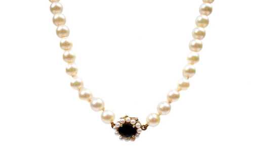An opera strand of pearls to a sapphire and pearl clasp in 9 carat yellow gold